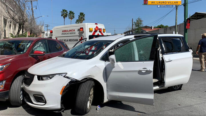 A member of the Mexican security forces stands next to a white minivan with North Carolina plates and several bullet holes, at the crime scene where gunmen kidnapped four U.S. citizens who crossed into Mexico from Texas, Friday, March 3, 2023.  